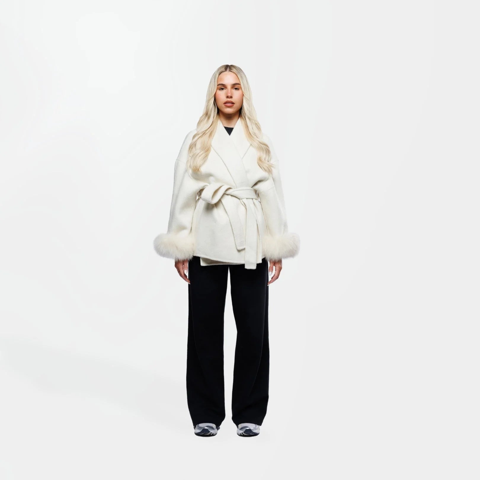 Women's cream jacket featuring a tie belt and fur cuffs, crafted from soft fabric for a stylish, cozy look.