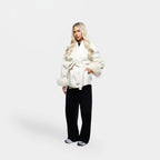 Women's cream jacket with tie belt, featuring soft fur cuffs and a comfortable fabric for a stylish, layered look.