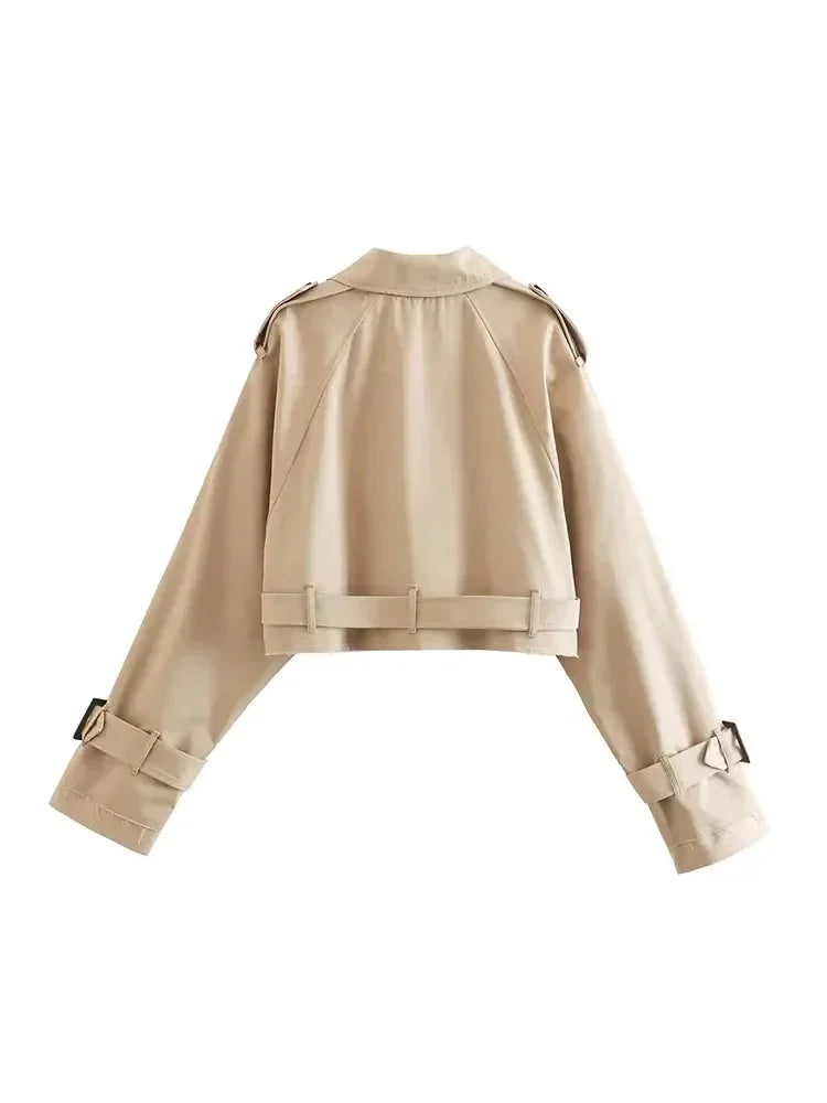 Women's cropped beige trench coat made of lightweight fabric, featuring long sleeves and classic double-breasted design.
