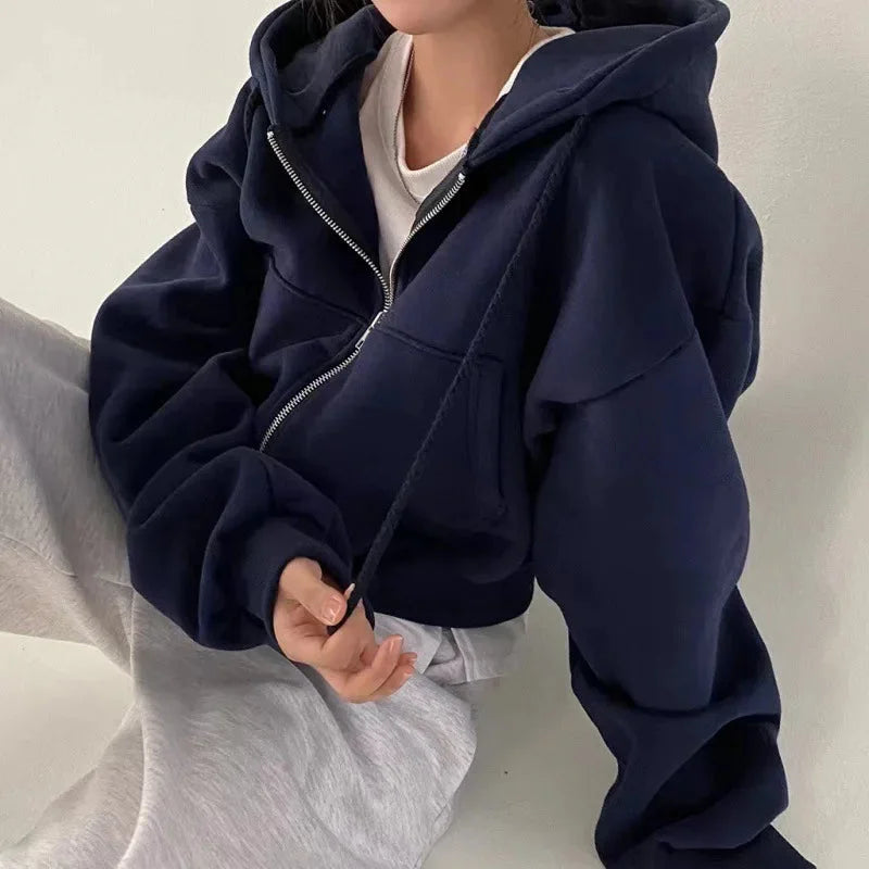 Women's cropped hooded sweatshirt with zip-up closure, made from soft cotton blend, featuring a comfortable fit and front…