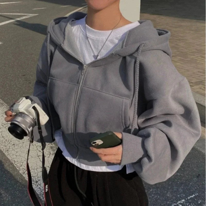 Women's cropped hooded sweatshirt featuring a zip-up closure, made from soft cotton blend for comfort and casual style.