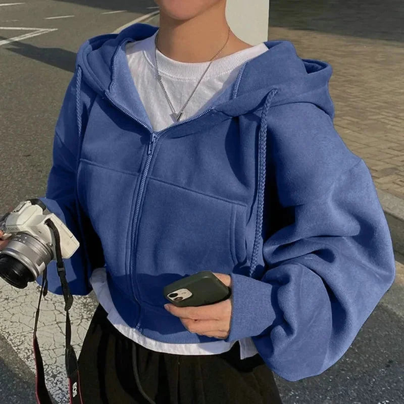 Women's cropped hooded sweatshirt in soft cotton blend, featuring a zip-up closure and a relaxed fit for comfort and style.