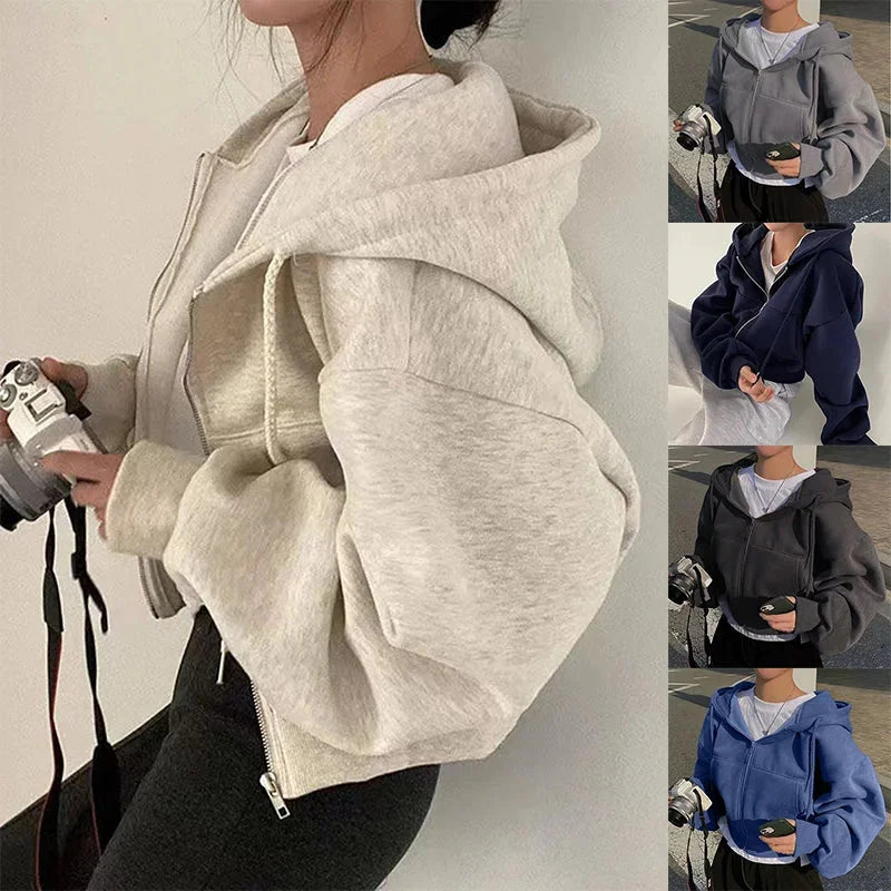 Women's cropped hooded sweatshirt with zip-up closure, featuring soft cotton blend fabric and a sporty, modern silhouette.