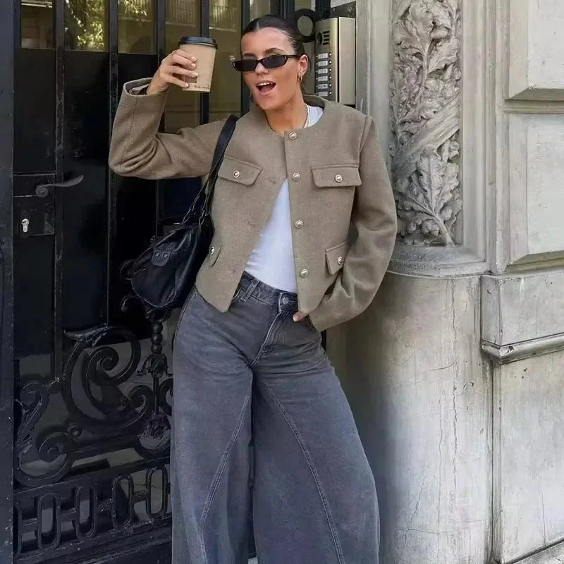 Women's cropped jacket in soft fabric featuring a button front and functional pocket details for a stylish, casual look.