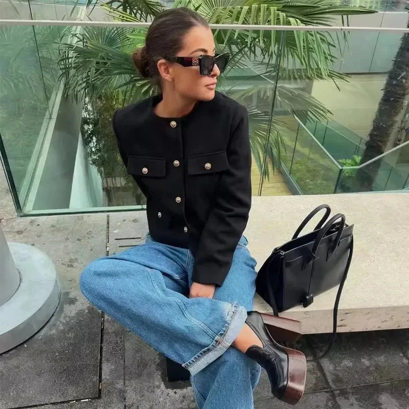 Women's cropped jacket with button front, crafted from soft cotton, featuring front pockets and a stylish, fitted design.