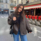 Women's dark brown faux shearling coat featuring wide lapels and soft texture, perfect for warmth and casual style.