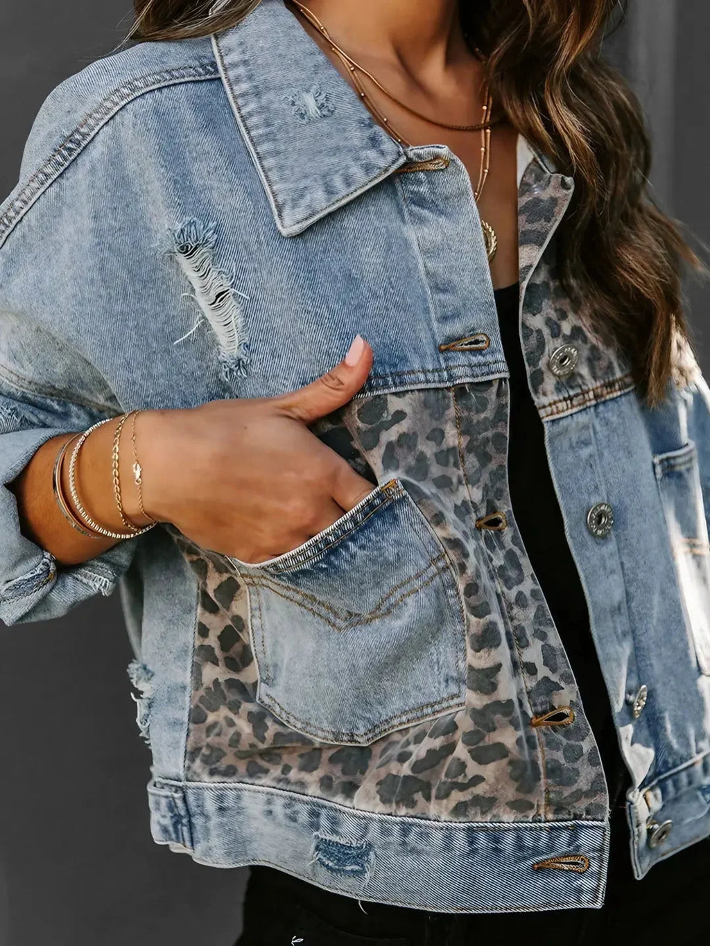 Women's denim jacket featuring a leopard print accent, crafted from durable cotton, with classic button closures and pockets.