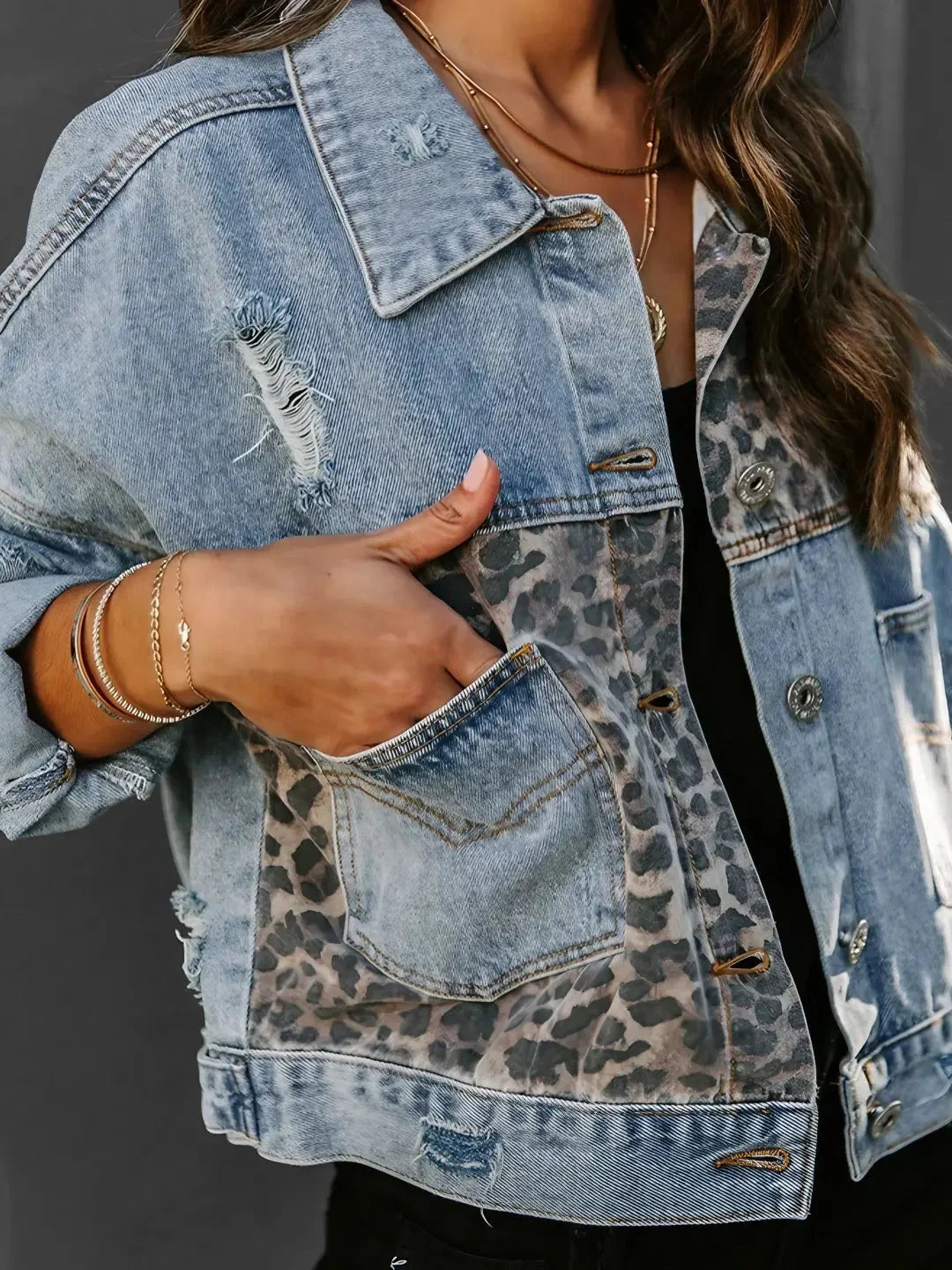 Women's denim jacket featuring a leopard print accent, crafted from durable cotton, with classic button closures and pockets.