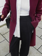 Women's double-breasted burgundy overcoat with lapel collar, made from warm wool blend, featuring a tailored fit and classic…