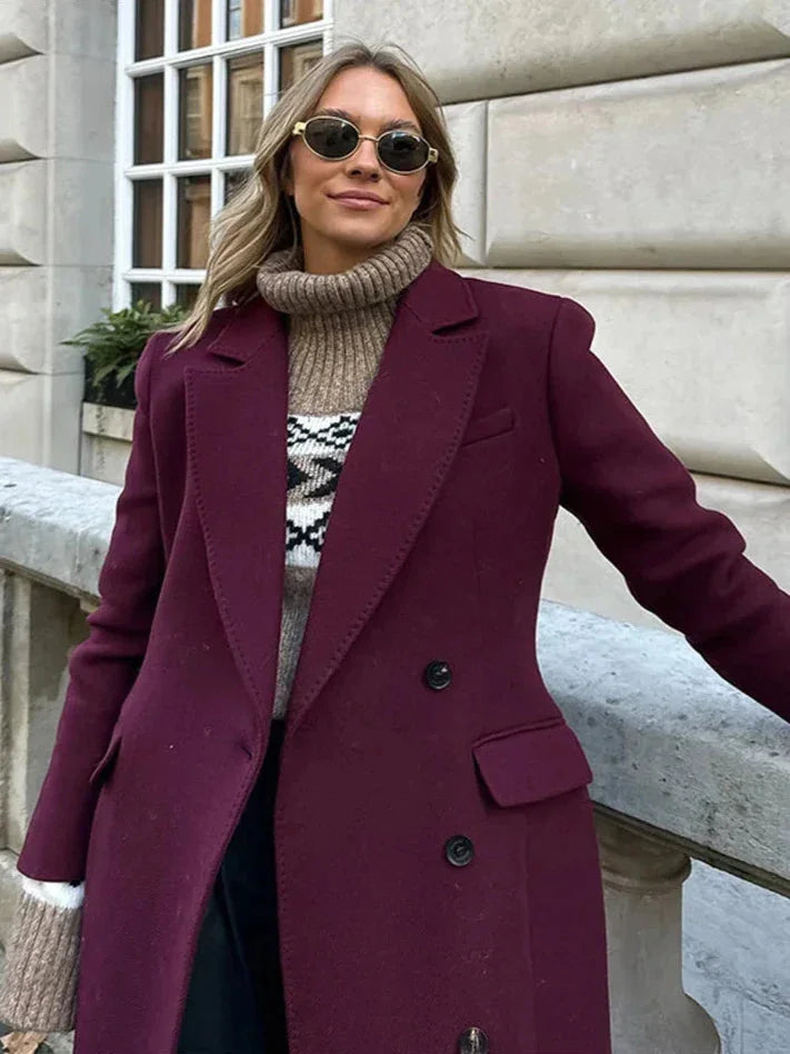 Women's double-breasted burgundy overcoat featuring a lapel collar, crafted from warm wool blend for cold weather.