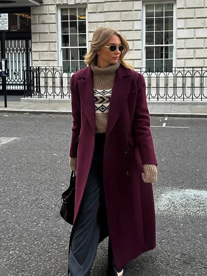 Women's double-breasted burgundy overcoat with a lapel collar, crafted from warm wool blend suitable for chilly weather.