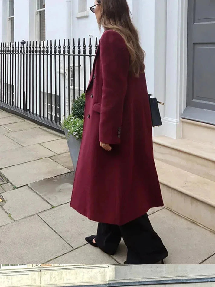 Women's double-breasted burgundy overcoat featuring a classic lapel collar, crafted from soft, warm fabric for comfort.