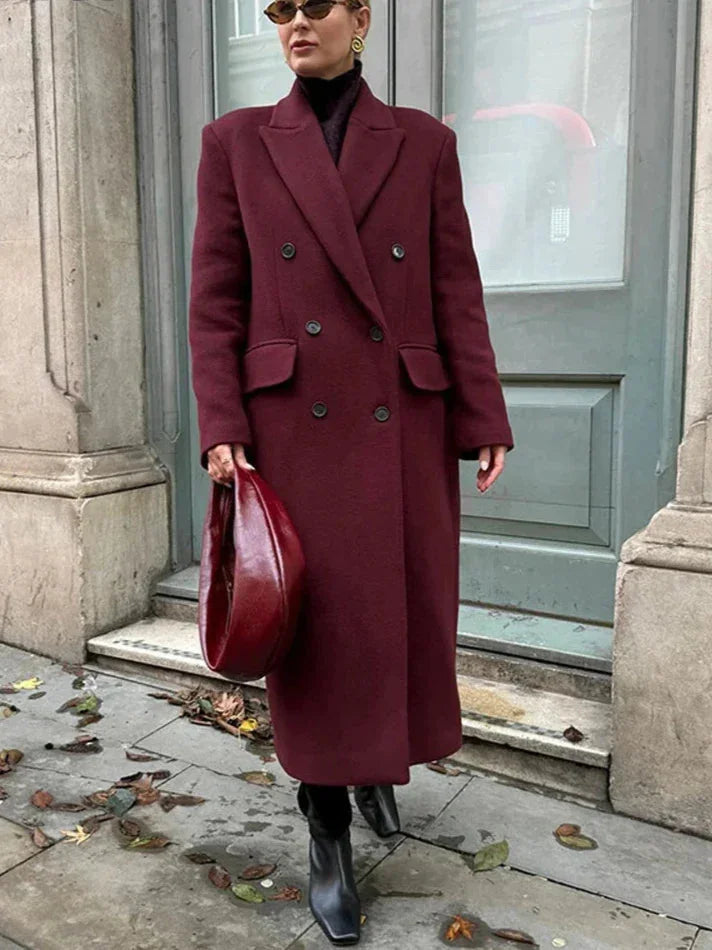 Women's double-breasted burgundy overcoat featuring a lapel collar and structured design, made from soft wool blend fabric.