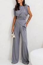 Women's two-piece set featuring a draped top and wide pants made from soft, breathable fabric for comfort and ease of…