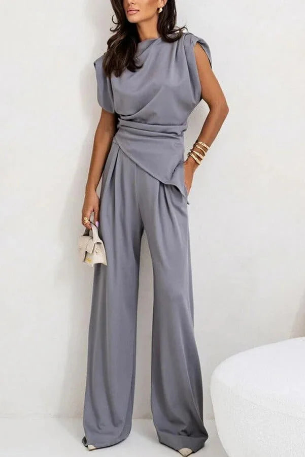 Women's two-piece set featuring a draped top and wide pants made from soft, breathable fabric for comfort and ease of…