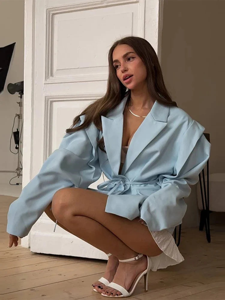 Women's lace-up blazer featuring structured shoulder pads and a soft fabric blend for a tailored, stylish look.