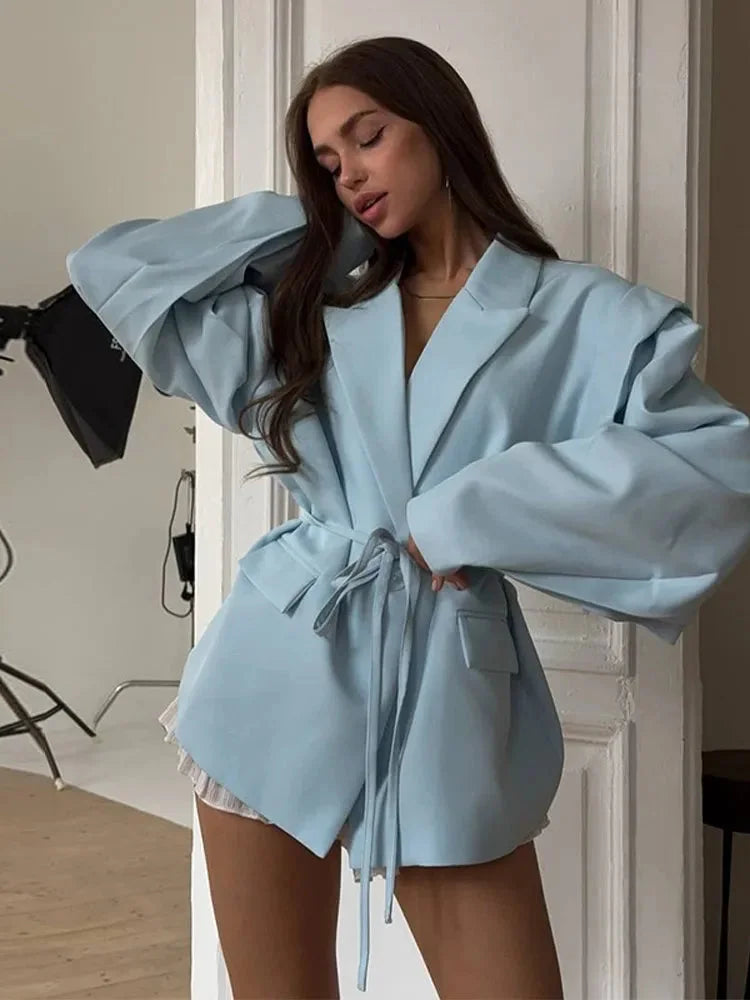 Women's lace-up blazer with shoulder pads, made from a lightweight fabric featuring a tailored fit and elegant silhouette.