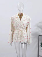 Women's lace-up blazer with shoulder pads, featuring a tailored fit and soft, breathable fabric for a polished look.