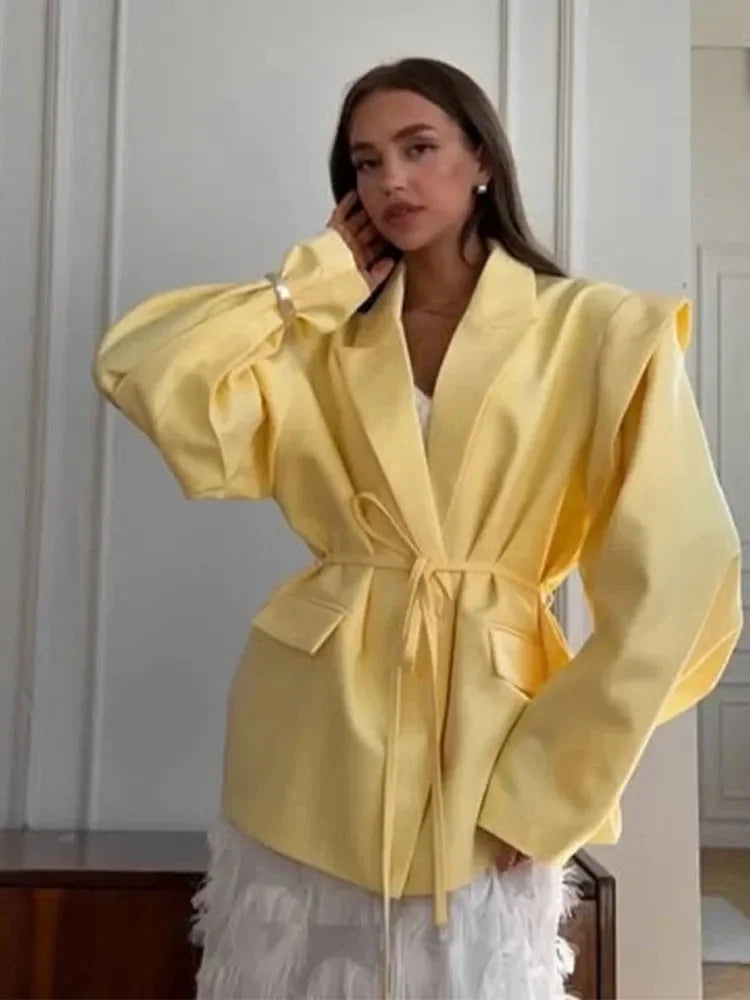 Women's lace-up blazer in soft fabric, featuring shoulder pads and a tailored fit for a polished, structured look.