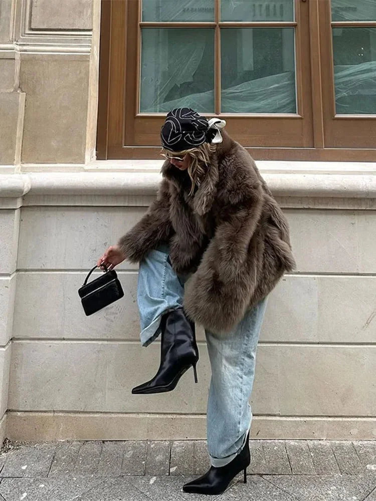 Brown women's faux fur coat with long sleeves, featuring a soft texture and classic silhouette for warmth and style.