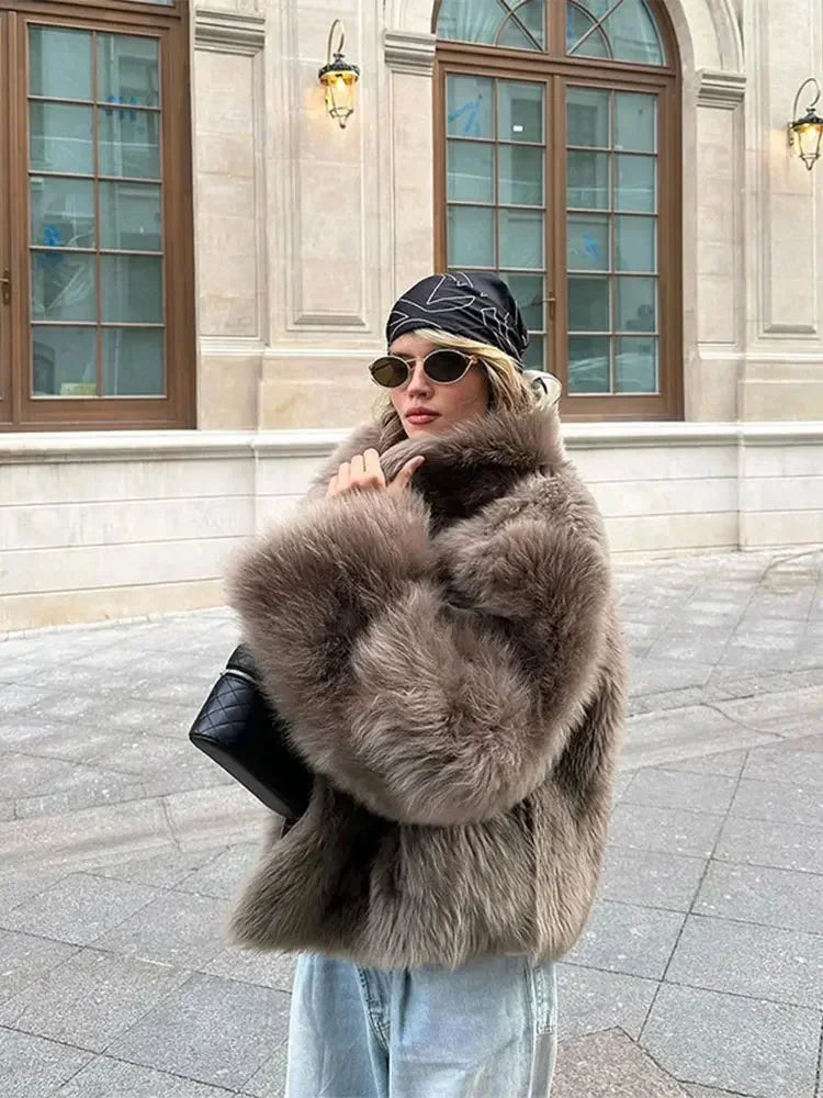 Brown women's faux fur coat with long sleeves, featuring a soft texture and stylish design for warmth and comfort.