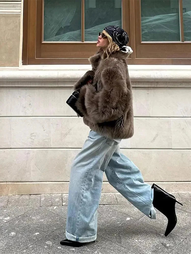 Brown women's faux fur coat featuring long sleeves and a soft, plush texture for warmth and style during colder months.
