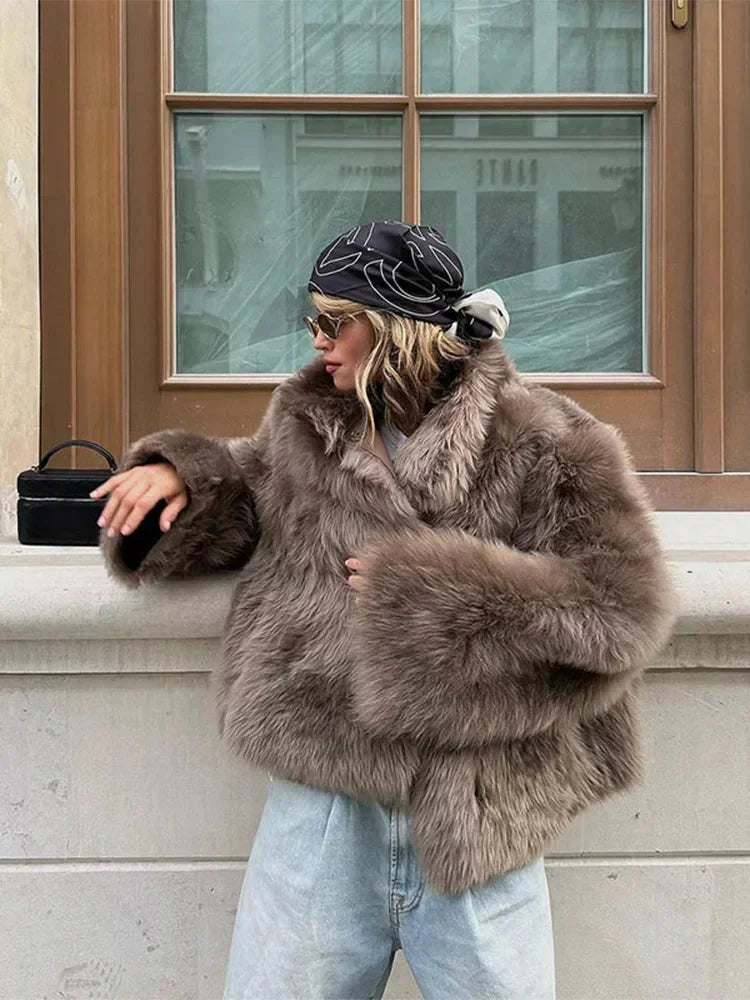 Brown women's faux fur coat with long sleeves and a plush texture, perfect for stylish warmth in cooler weather.