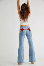 Women's flared jeans in denim with red star embroidery on pockets, featuring a comfortable high-waist fit and classic style.