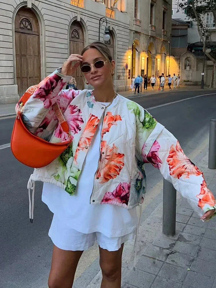 Women's floral bomber jacket in lightweight fabric with drawstring details for adjustable fit and vibrant floral print.