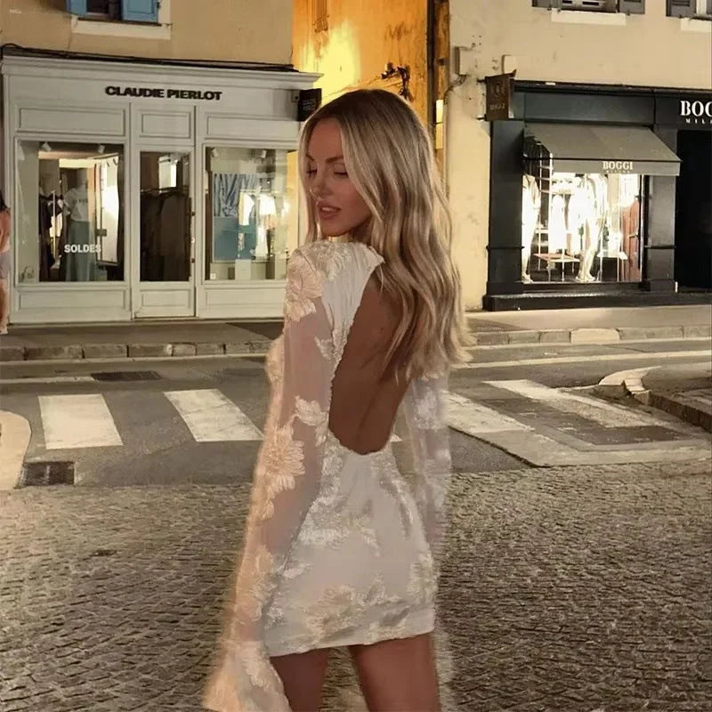 Women's floral mini dress made from soft cotton with long flared sleeves and a flowing silhouette, perfect for casual…