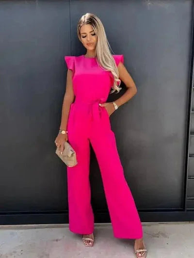 Lightweight cotton jumpsuit featuring flutter sleeves, wide-leg design, and a bow tie at the waist for a flattering fit.