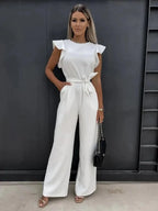 Women's wide-leg jumpsuit in soft fabric, featuring flutter sleeves and a stylish bow tie at the waist for a relaxed fit.