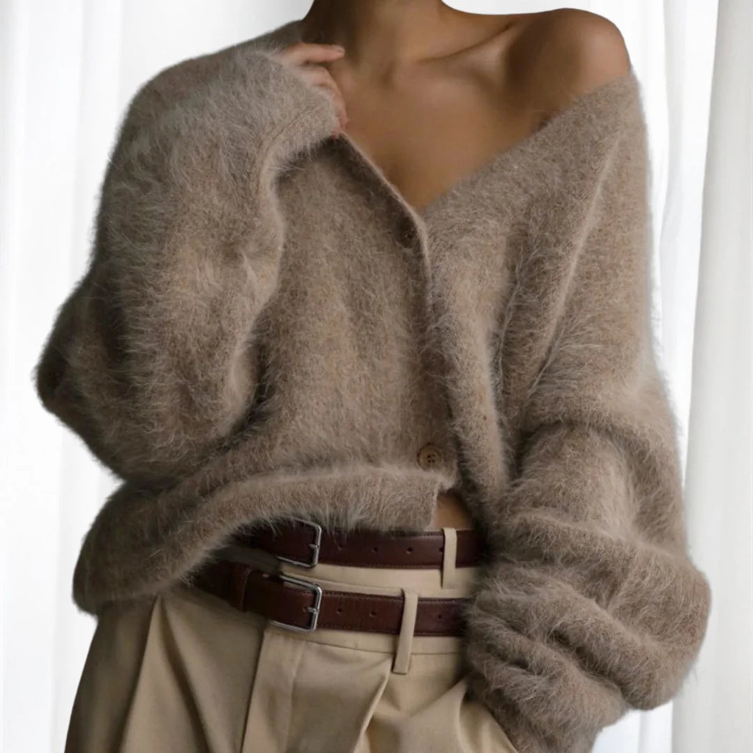 Cozy women's oversized cardigan featuring fuzzy texture and button-front design, perfect for layering in cooler weather.