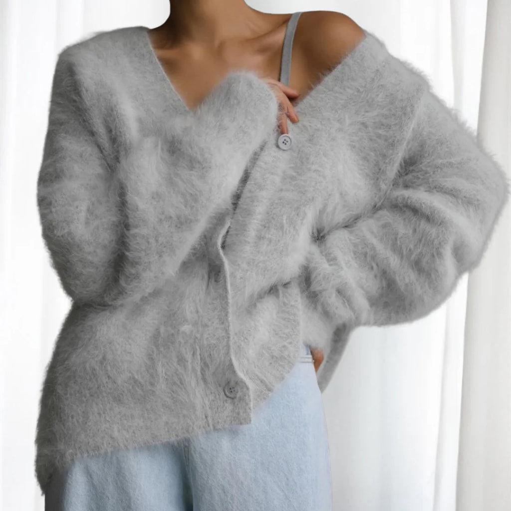 Cozy women's oversized cardigan featuring fuzzy texture and button-front design, perfect for casual layering in cooler…