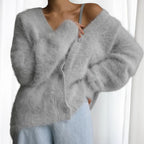 Cozy women's oversized cardigan featuring fuzzy texture and button-front design, perfect for casual layering in cooler…