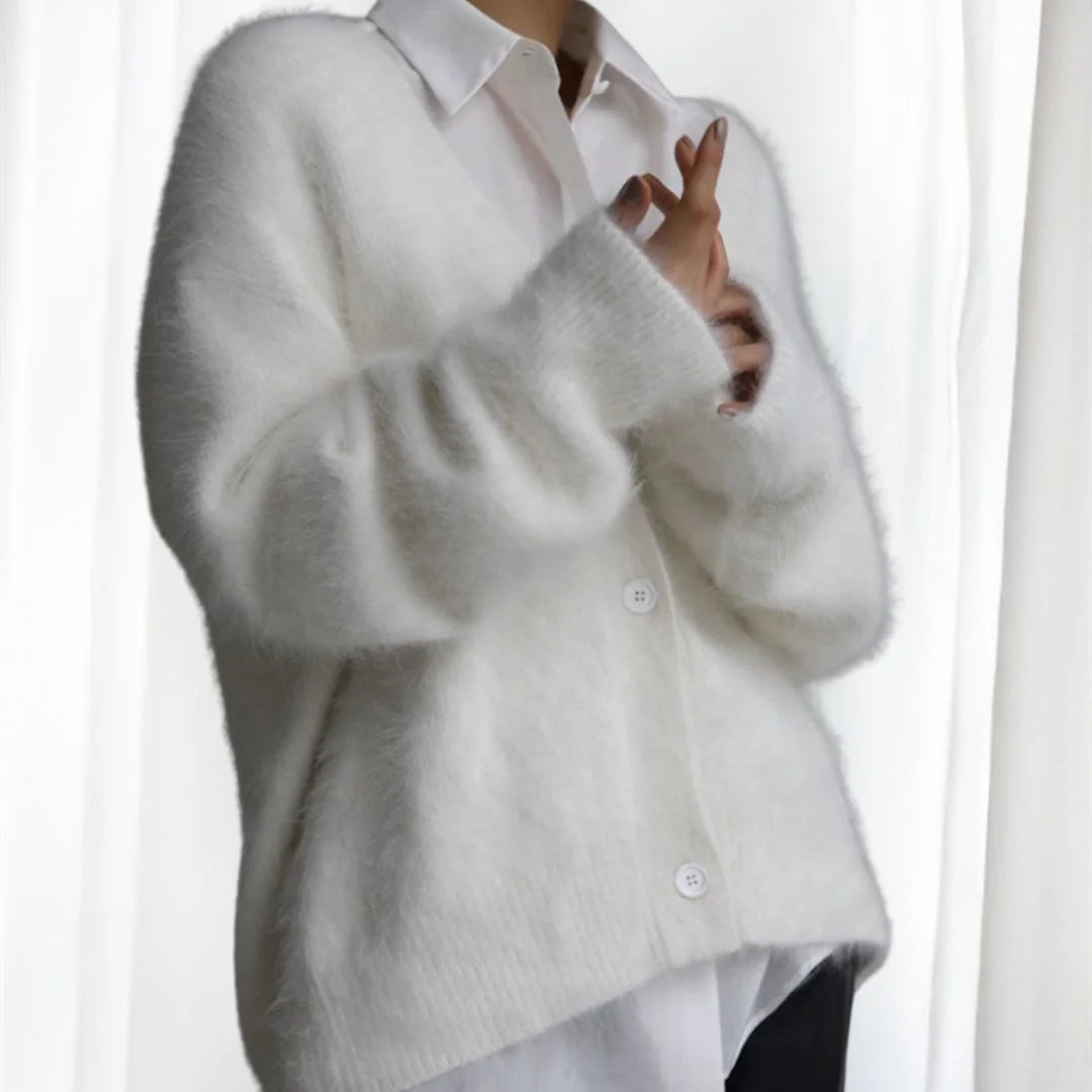 Women's oversized cardigan made of soft, fuzzy fabric with button front and spacious pockets for cozy layering.