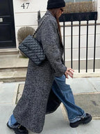 Women's gray oversized coat featuring long sleeves, crafted from soft fabric with a relaxed fit and front pockets for…