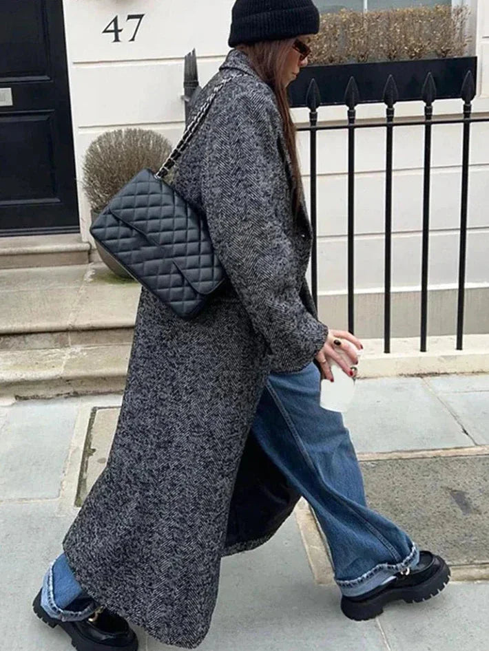 Women's gray oversized coat featuring long sleeves, crafted from soft fabric with a relaxed fit and front pockets for…