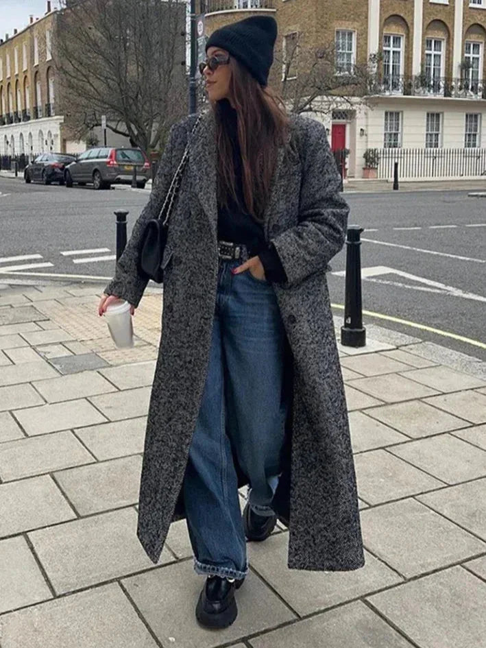 Women's gray oversized coat with long sleeves, soft fabric, relaxed fit, and stylish large pockets for everyday wear.
