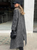 Women's gray oversized coat with long sleeves, made from soft wool blend fabric, featuring a relaxed fit and large front…