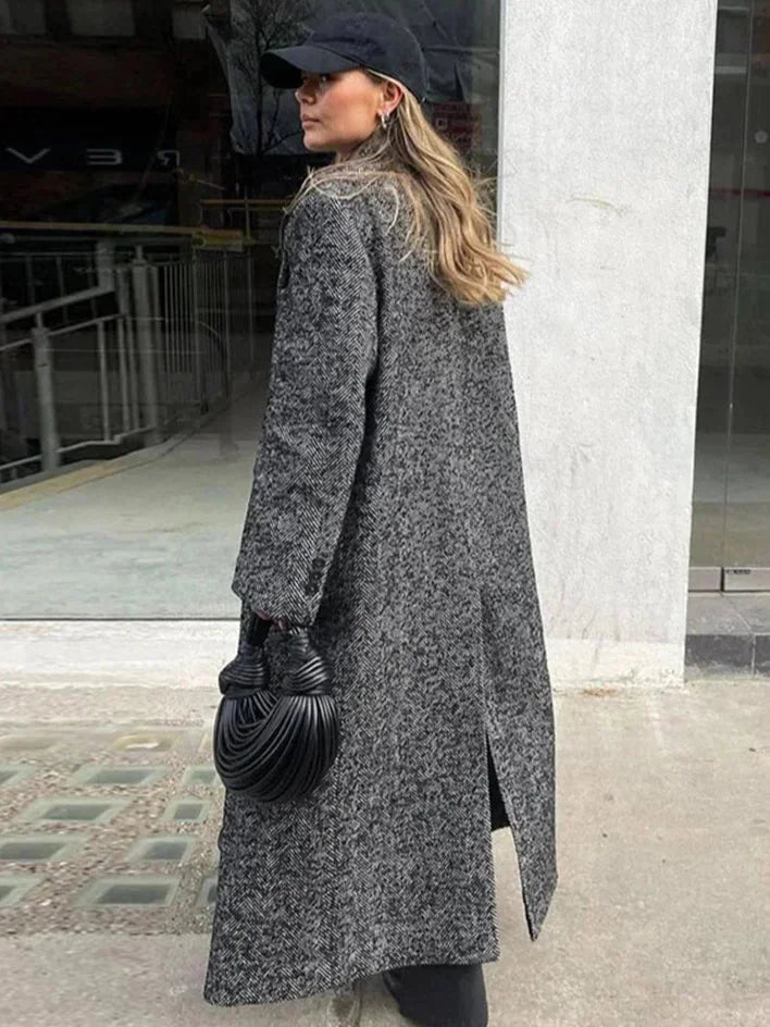 Women's gray oversized coat with long sleeves, made from soft wool blend fabric, featuring a relaxed fit and large front…