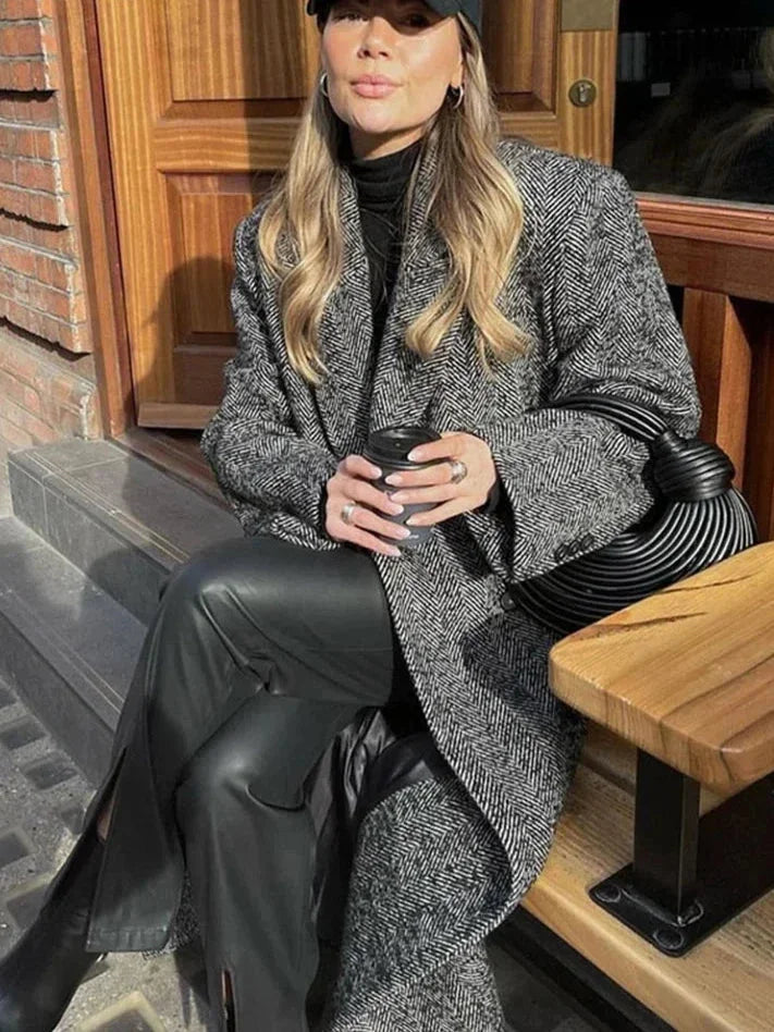 Women's gray oversized coat featuring long sleeves, made from soft wool blend with a relaxed fit for comfort and style.