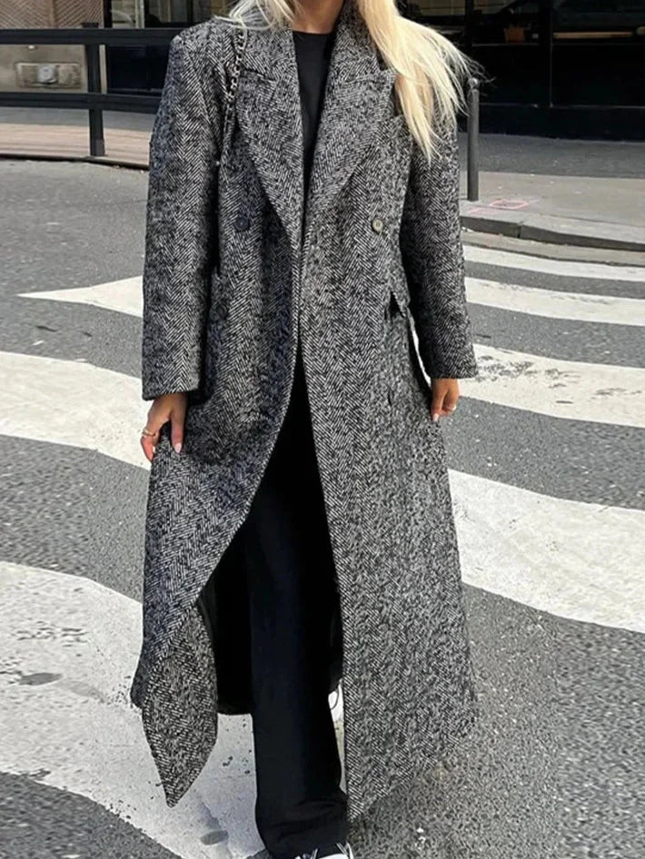 Women's gray oversized coat featuring long sleeves, made from warm wool blend, with a relaxed fit and side pockets.