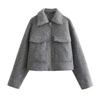 Women's grey cropped jacket with long sleeves, featuring a soft fabric and stylish silhouette for versatile layering.