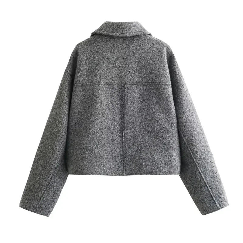 Women's grey cropped jacket with long sleeves, made from soft cotton blend, featuring a classic collar and front button…
