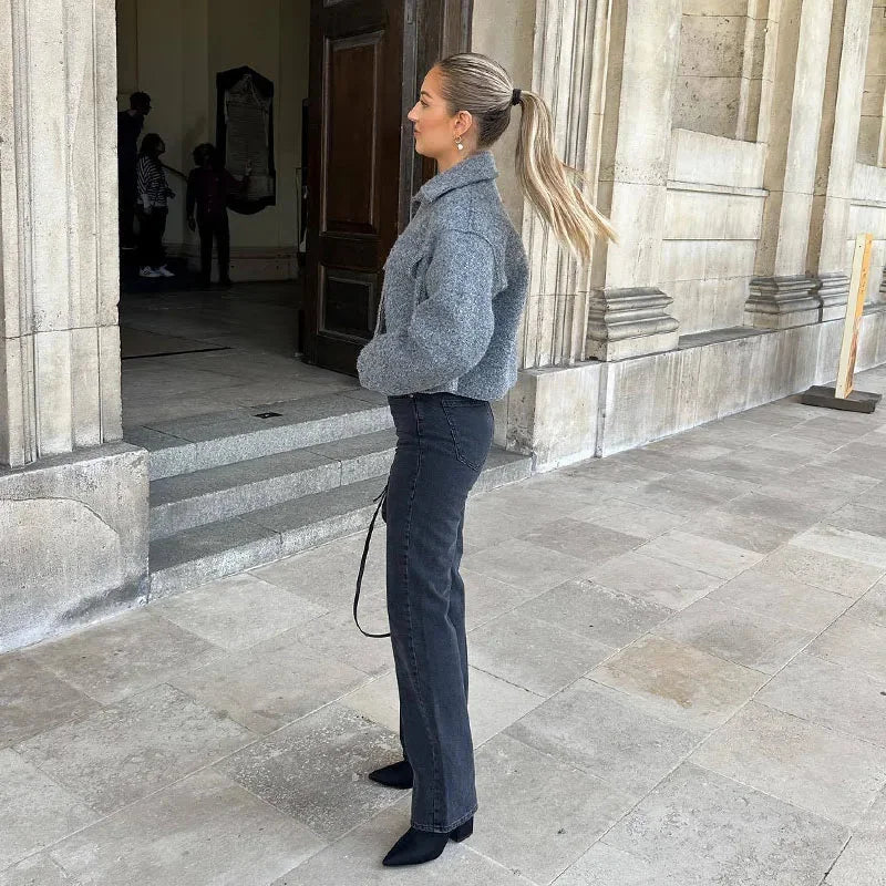 Women's grey cropped jacket made of soft fabric, featuring long sleeves and a tailored fit for a stylish look.