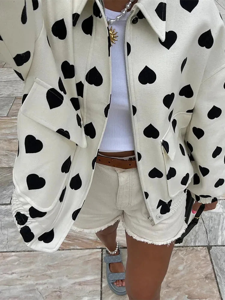 Women's heart-patterned jacket featuring a front closure, crafted from soft fabric for comfort and warmth. Perfect for…