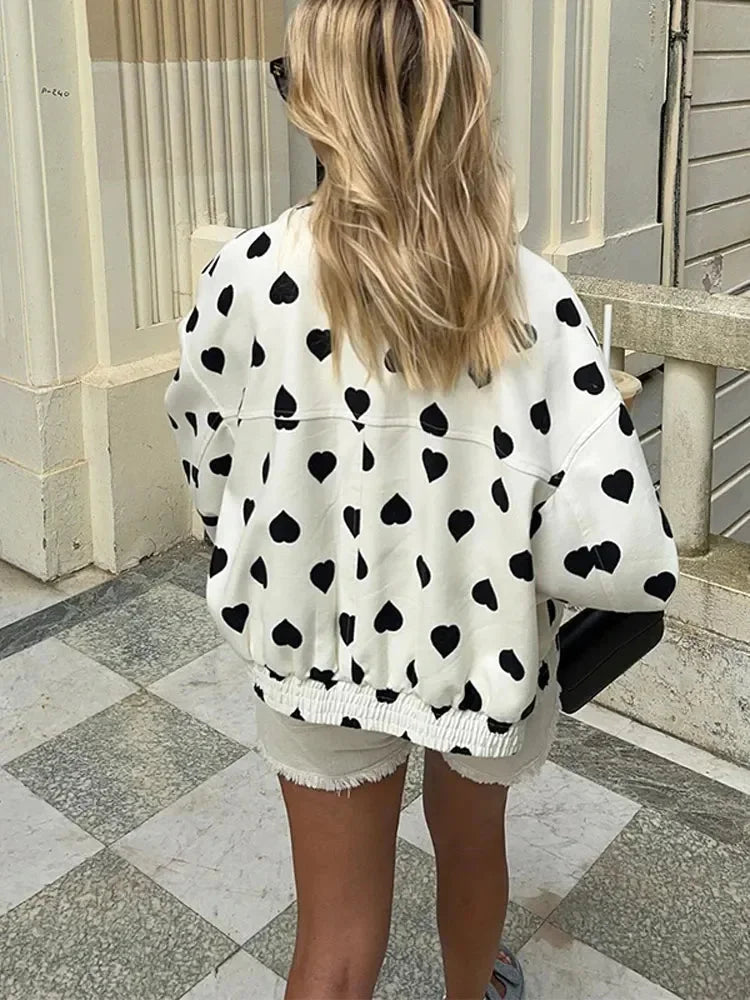 Women's heart-patterned jacket with front closure, featuring a soft fabric and cozy design, perfect for casual wear.