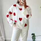 Women's ivory sweater made of soft knit, featuring a casual red heart pattern for an everyday comfy look.