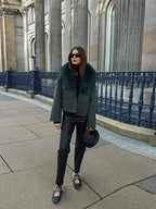 Charcoal gray women's jacket with a soft faux fur collar, featuring a zip front and cozy pockets for warmth and comfort.